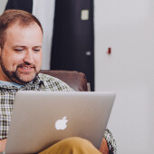 Man comparing top power deals on Power Compare on a laptop